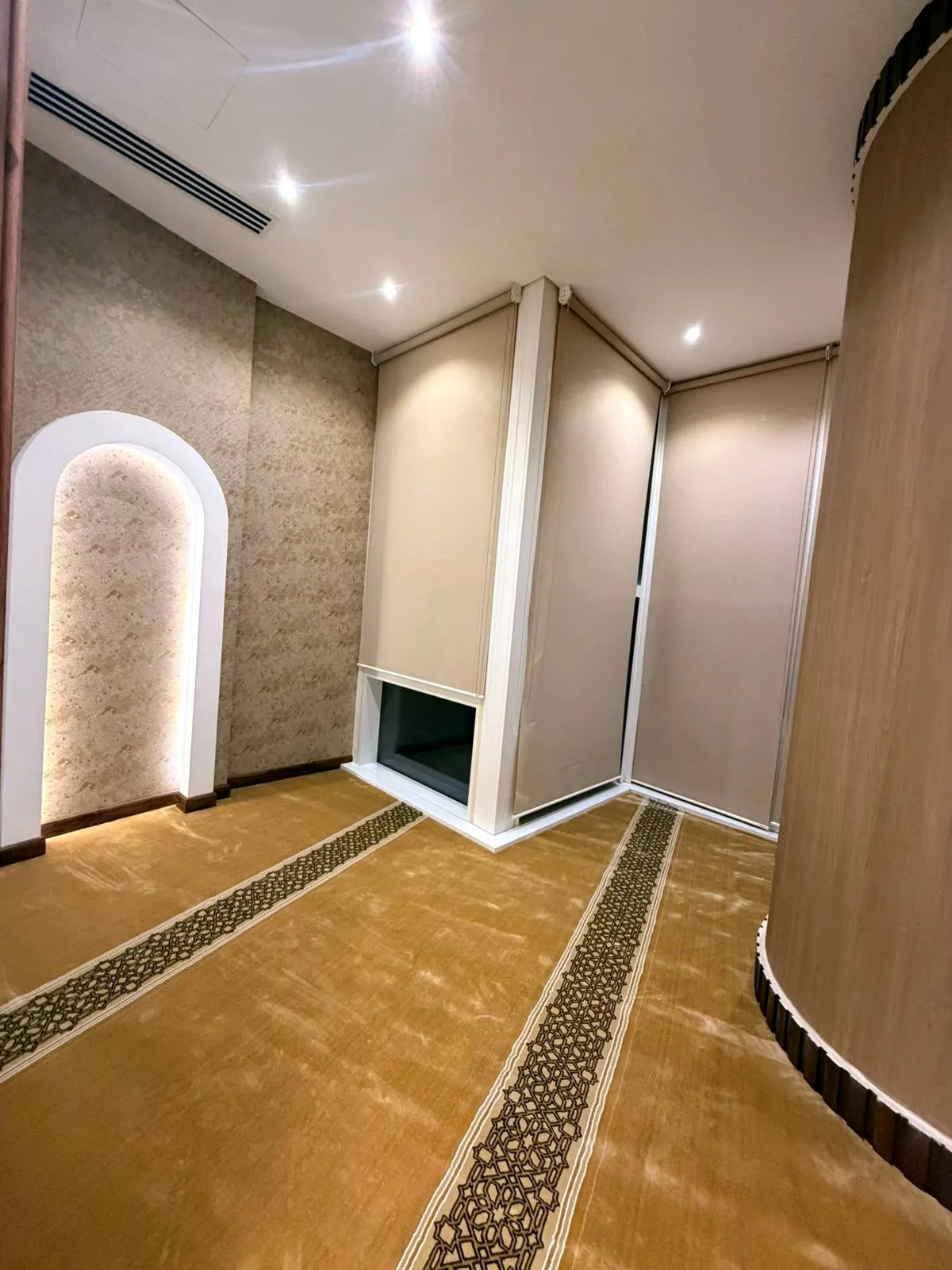 Prayer room with carpet, cove lighting and blinds