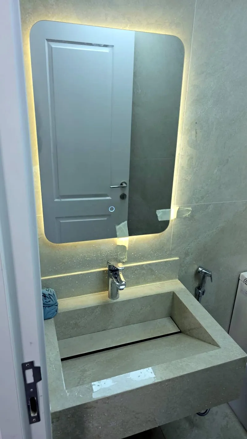 Wet-area basin, stone top and LED mirror after handover