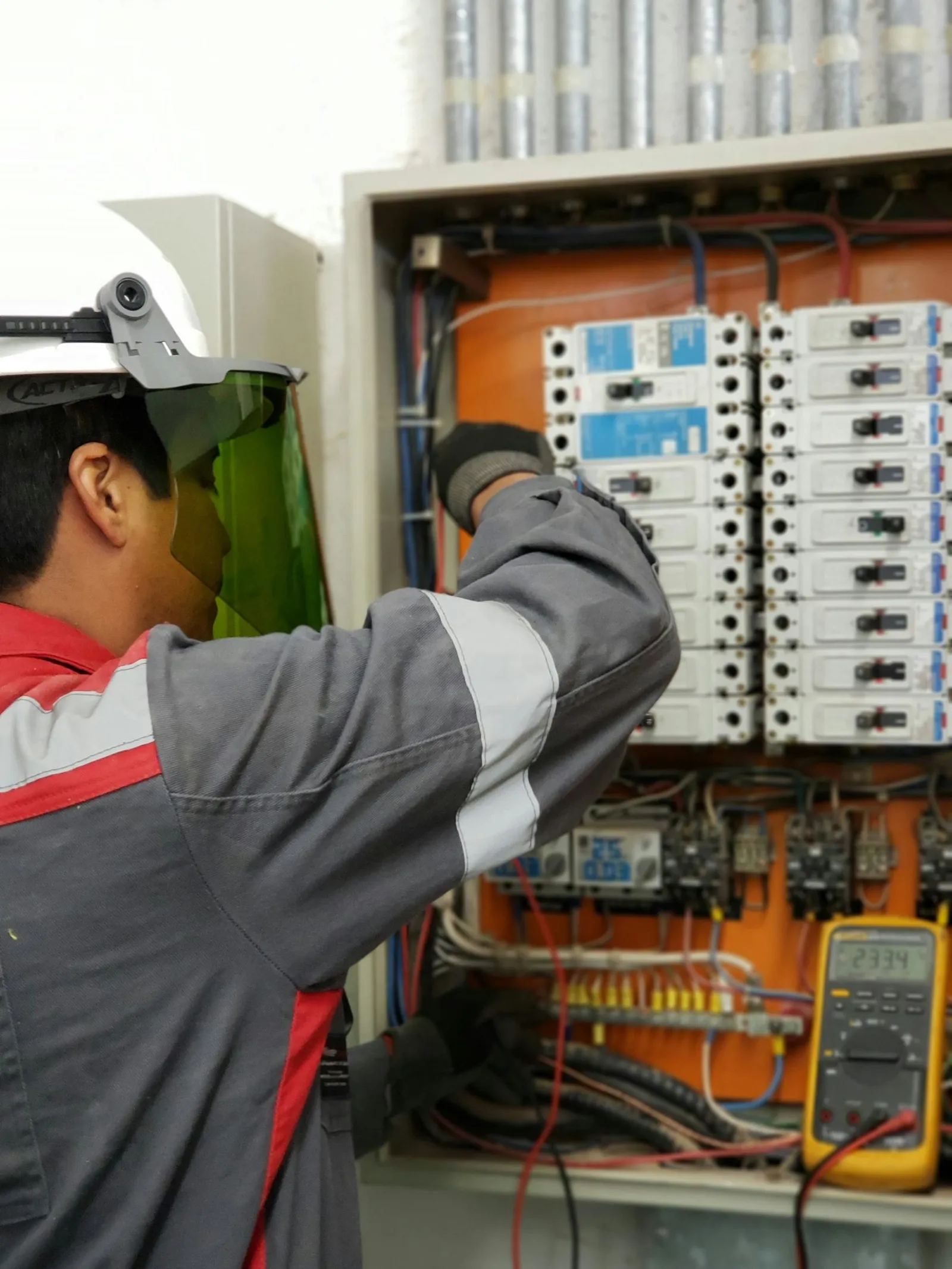Engineer testing an electrical panel before documented fit-out close-out