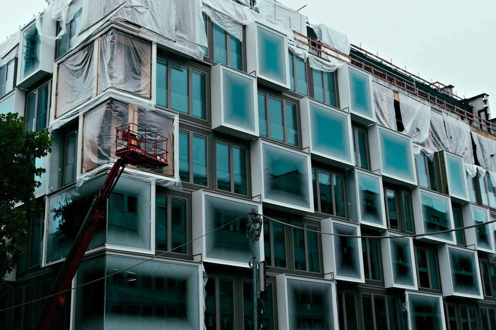 Building facade under construction with scaffolding and cladding
