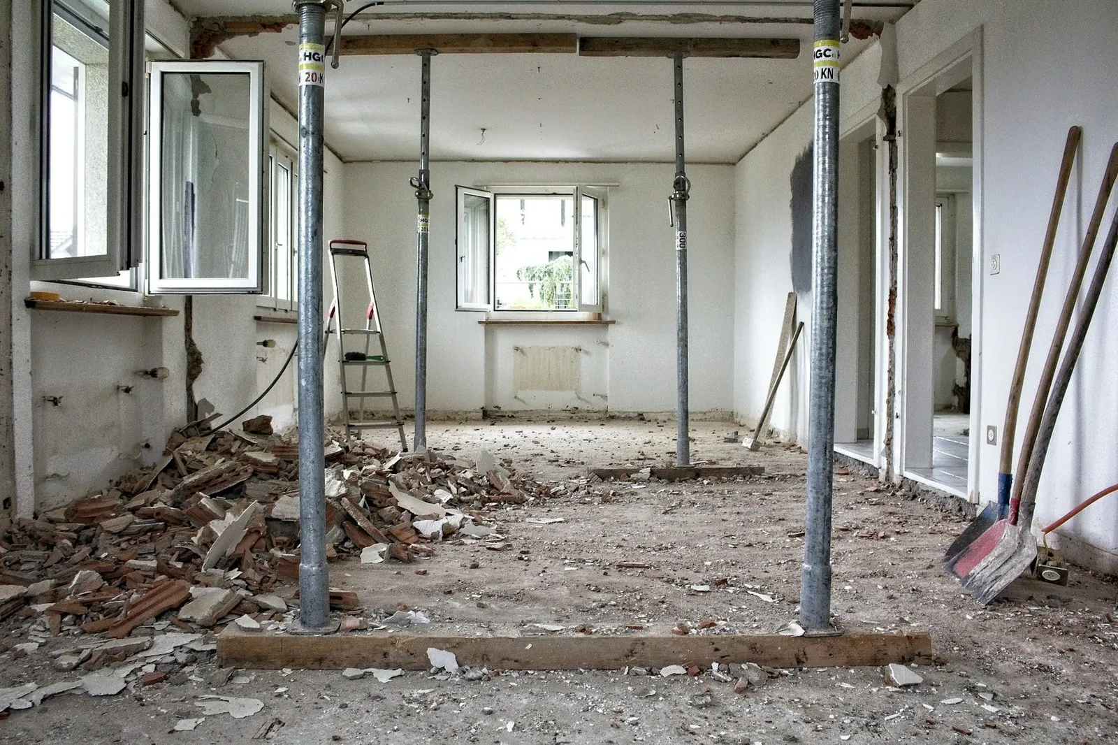 Interior of a retail unit being stripped out, with partitions removed and debris being cleared